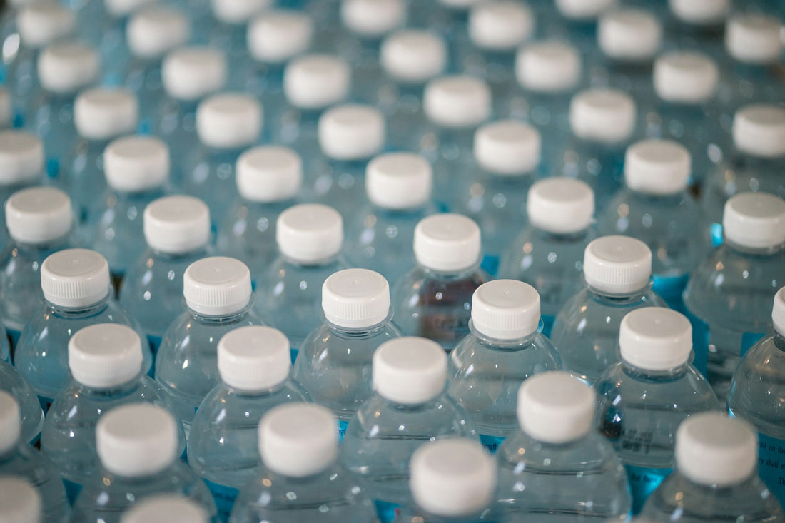 Multiple plastic bottles on a manufacturing line