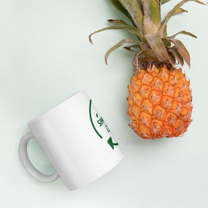 SimpleCycle White Glossy Mug side view next to a pineapple
