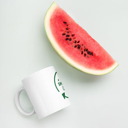 SimpleCycle White Glossy Mug next to a watermelon